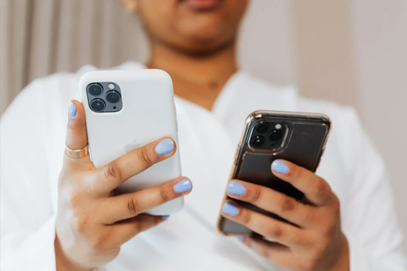 Woman uses two phones with extra SIM card at the same time