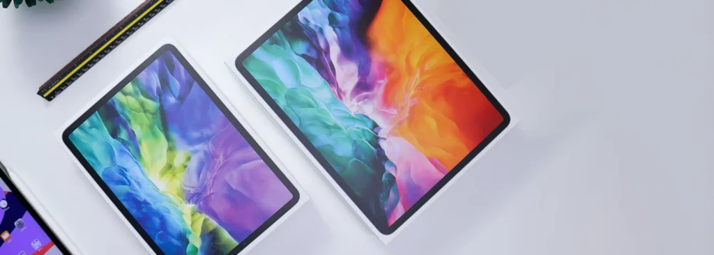 Apple iPad Air and Pro models lying next to each other with active displays