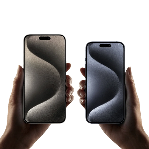 Close up of two hands holding iPhone 15 Pro and Pro Max models, each with unlocked display and Dynamic Island