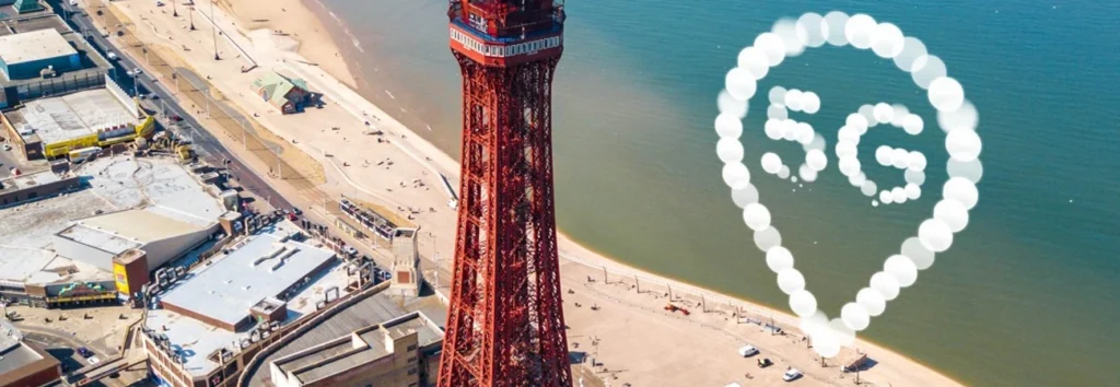 UK beach with cell phone tower next to giant 5G graphic